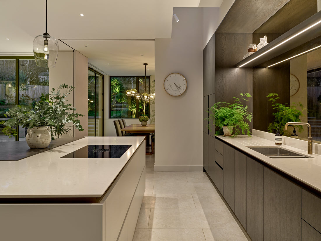 Lighting design in open-plan kitchen in Wimbledon new build, with glass pendants and joinery lighting.
