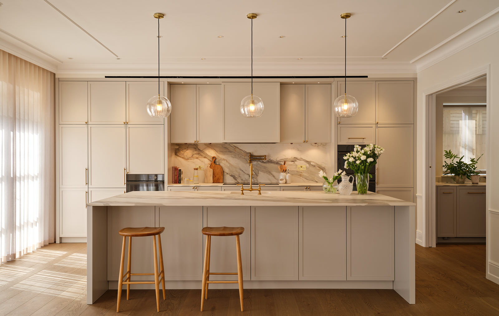 Architectural fixtures and pendant lights over the kitchen island in house in Wimbledon Village
