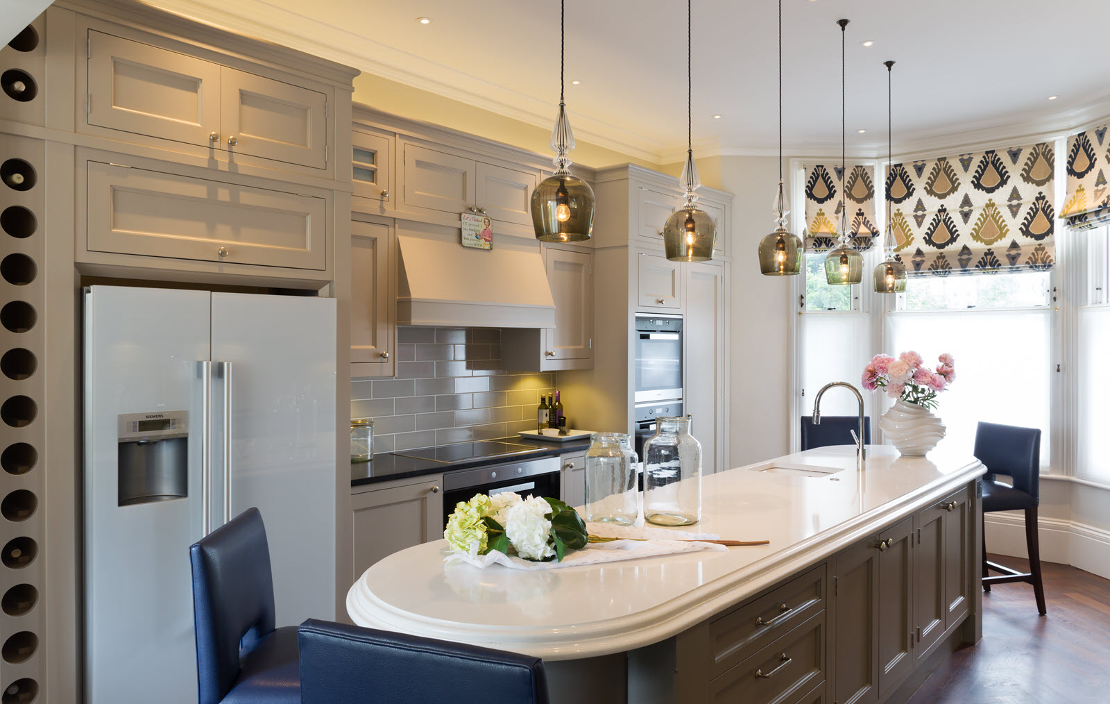 Architectural fixtures and pendant lights over the kitchen island in house in Wimbledon Village